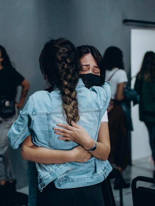 Two young girls huffing each others upon the death of a beloved one